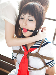 Dimdim Asian in uniform is tied in ropes by another sexy cupcake